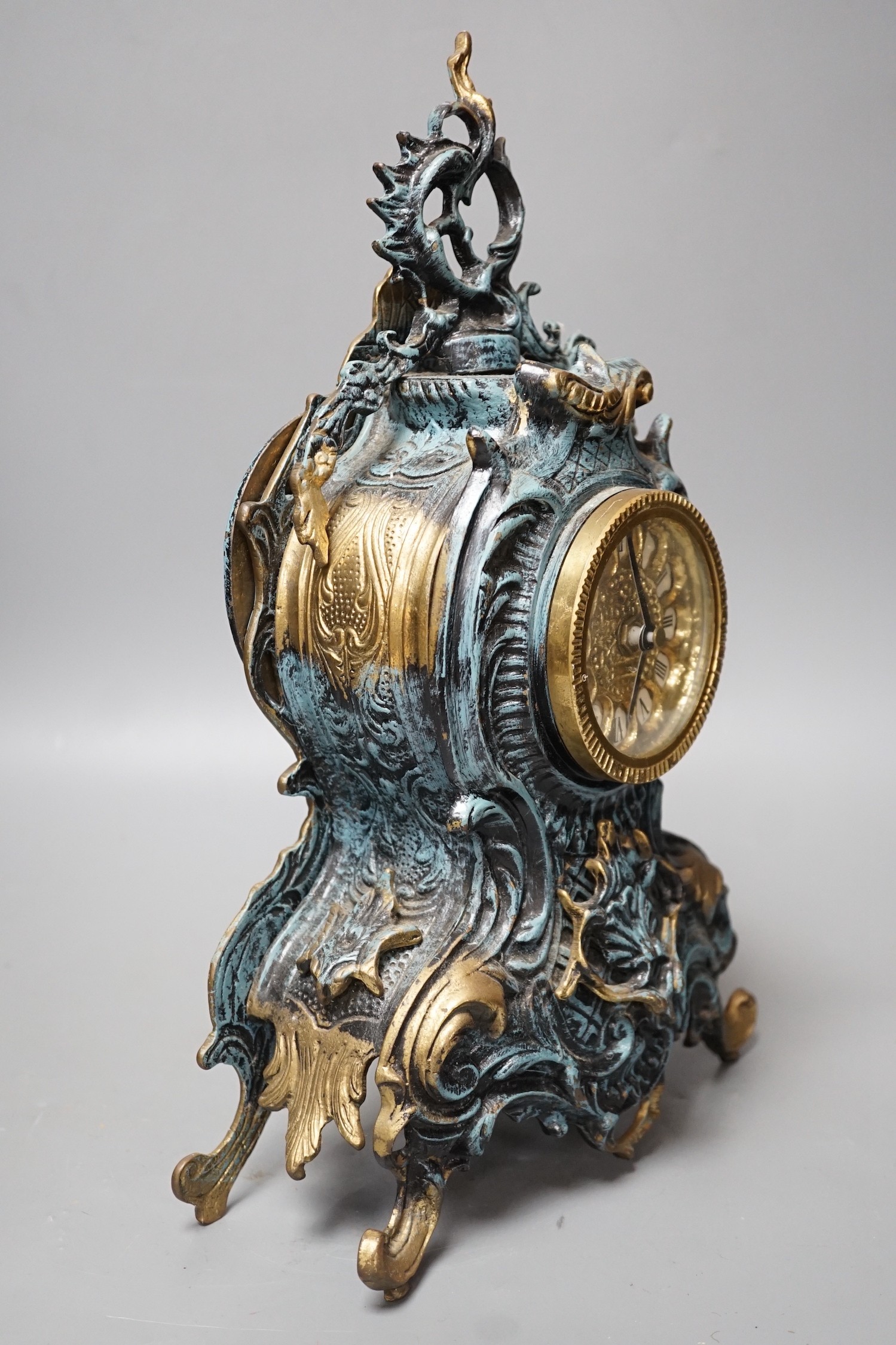 A Louis XV style spelter and parcel gilt mantel timepiece, 37cm